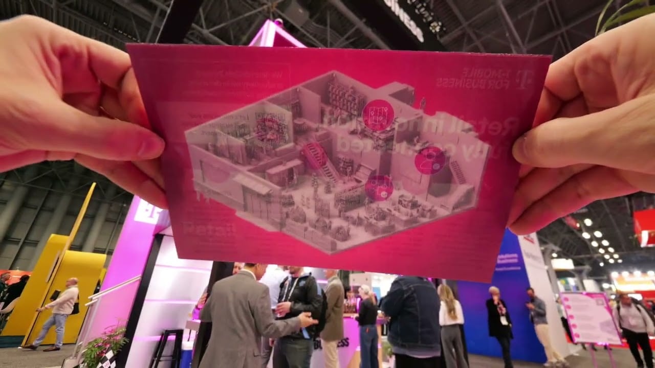 Lenticular Trade Show Displays Lenticular Trade Show Displays: Attendee holding a T-Mobile lenticular flip card at NRF Retail's Big Show with the booth in the background